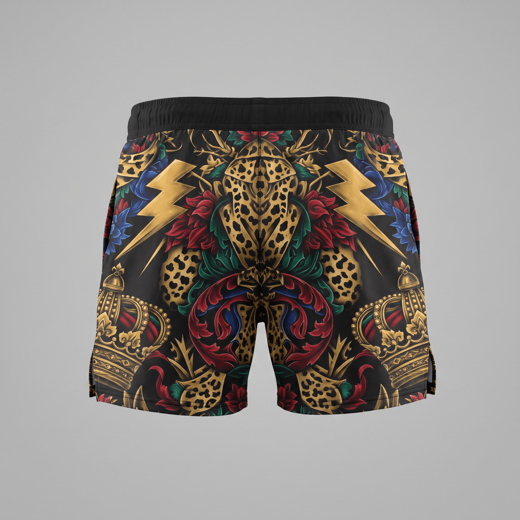 Black athletic shorts featuring a bold baroque tattoo print with gold crowns, lightning bolts, and floral patterns.