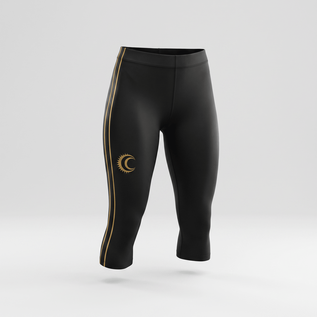 Black cropped athletic leggings with gold side stripes and sun-and-moon logo on right thigh.