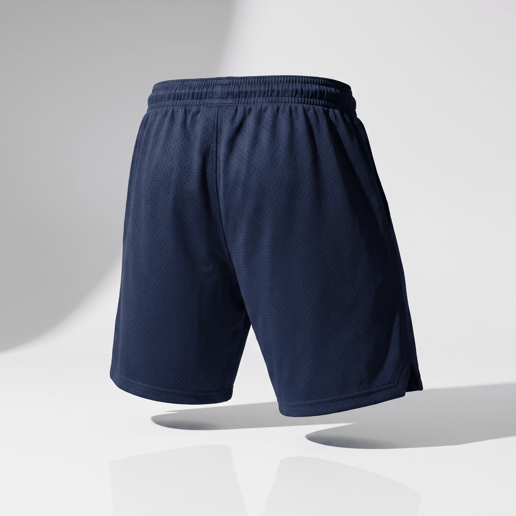 Back view of dark navy blue athletic mesh shorts featuring an elastic waistband on a white studio background.