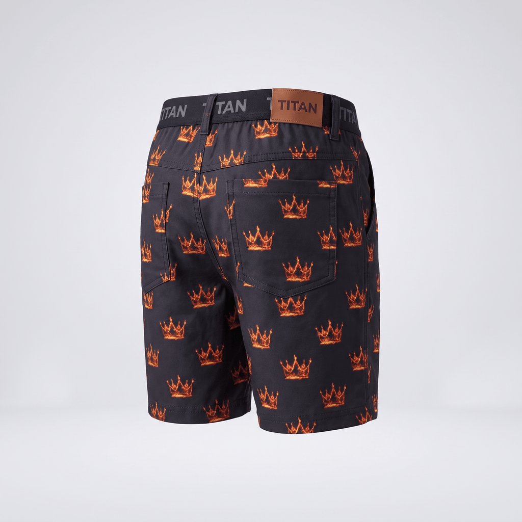 Back view of black Titan shorts with an all-over flaming crown print and brown leather waistband patch.