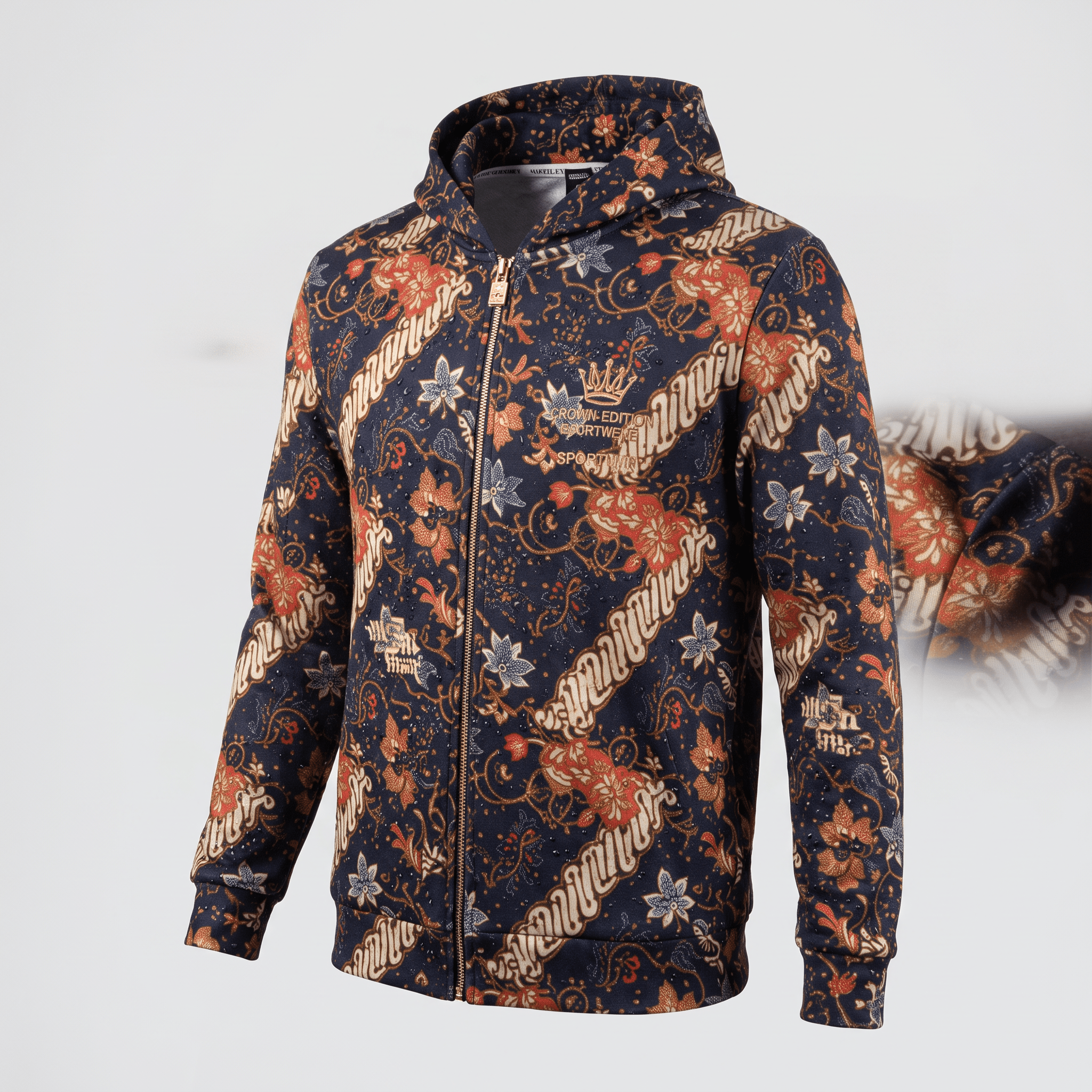 Navy blue zip-up hoodie featuring a traditional batik floral pattern in orange and white with a crown logo.