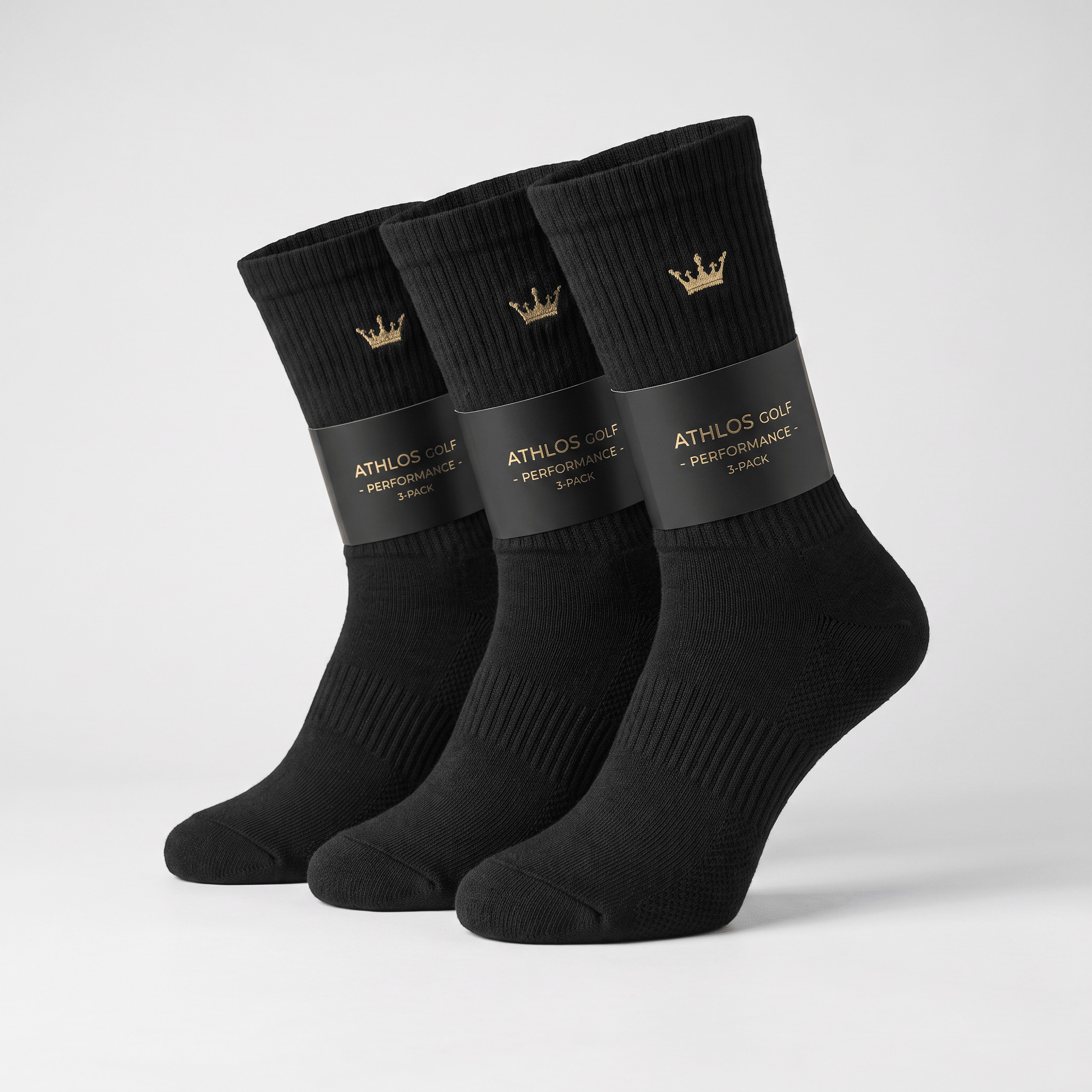 Three-pack of black crew socks with gold crown logo, wrapped in Athlos Golf branding.