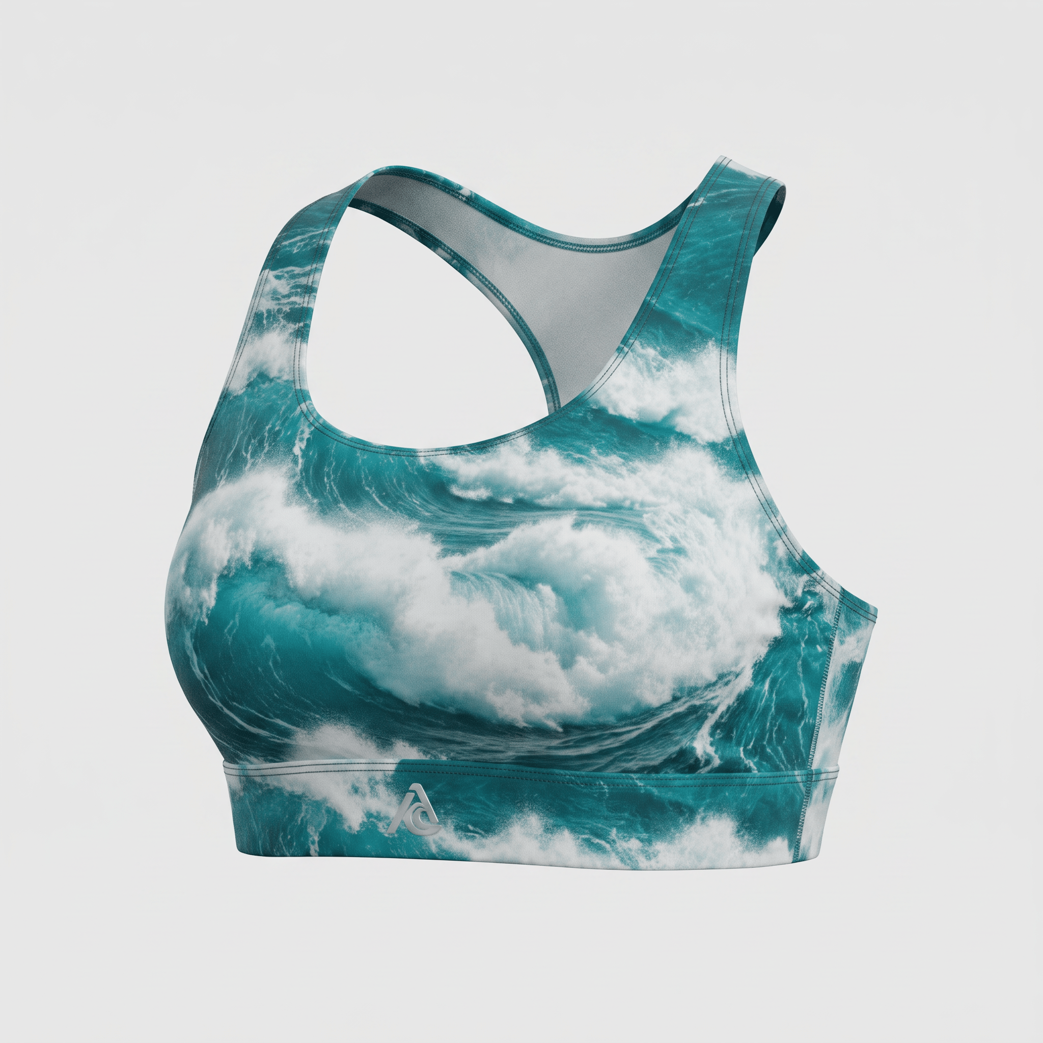 Teal and white ocean wave print sports bra with a racerback style and silver logo.
