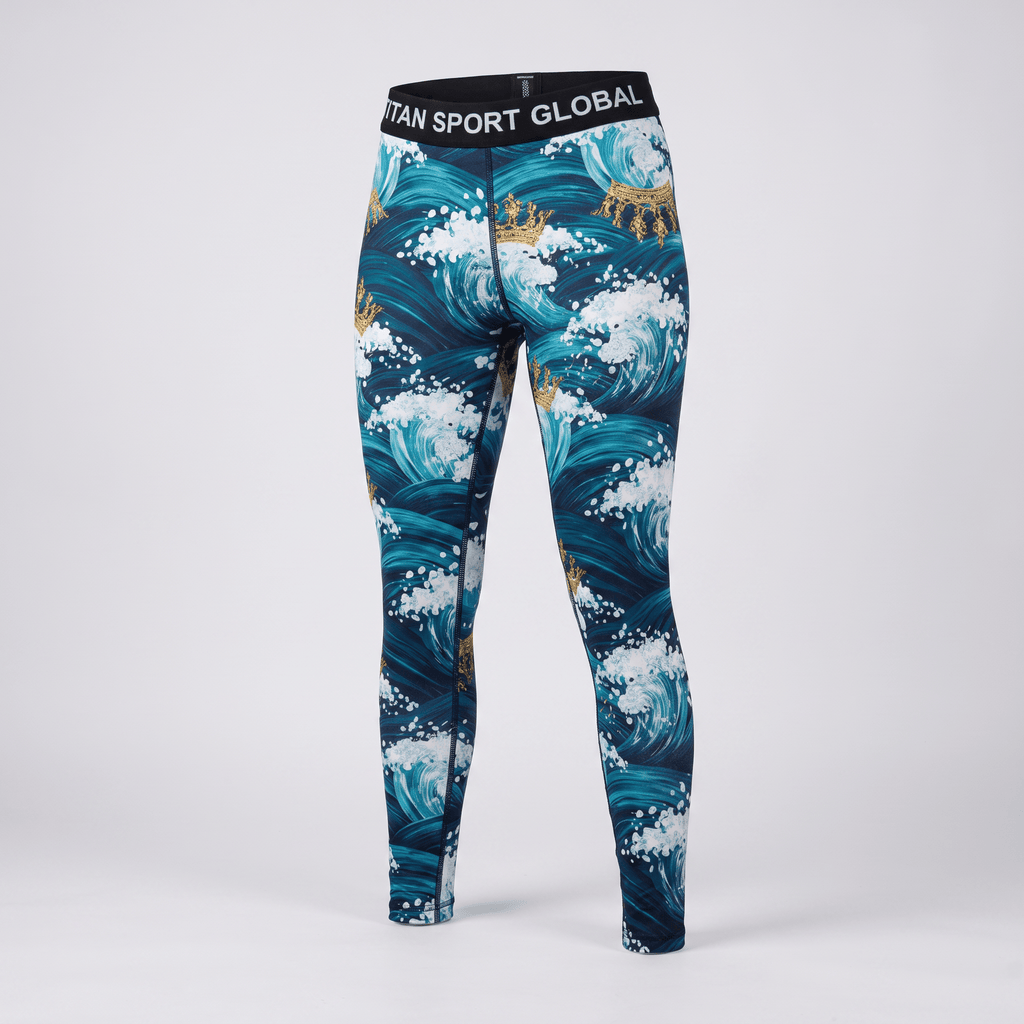 Blue athletic leggings featuring an ocean wave and gold crown pattern with a black branded waistband.