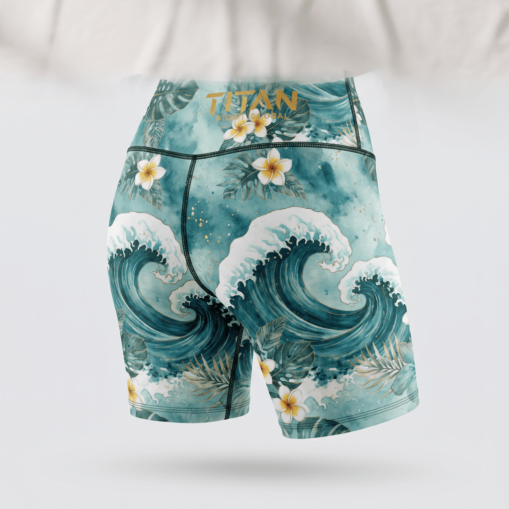 Teal athletic shorts featuring a watercolor ocean wave and tropical flower print, back view.