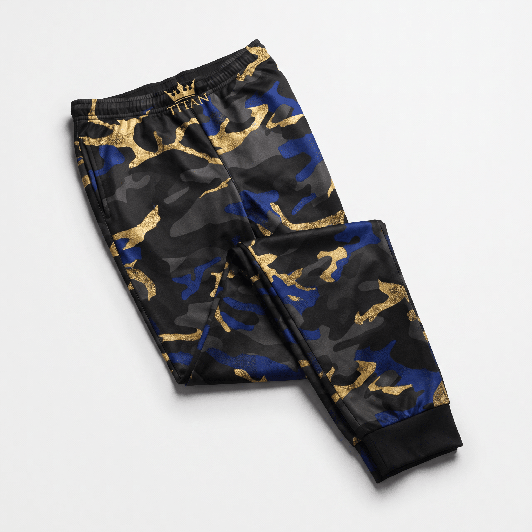 Black, blue, and gold camo joggers with Titan crown logo on waistband laid flat.