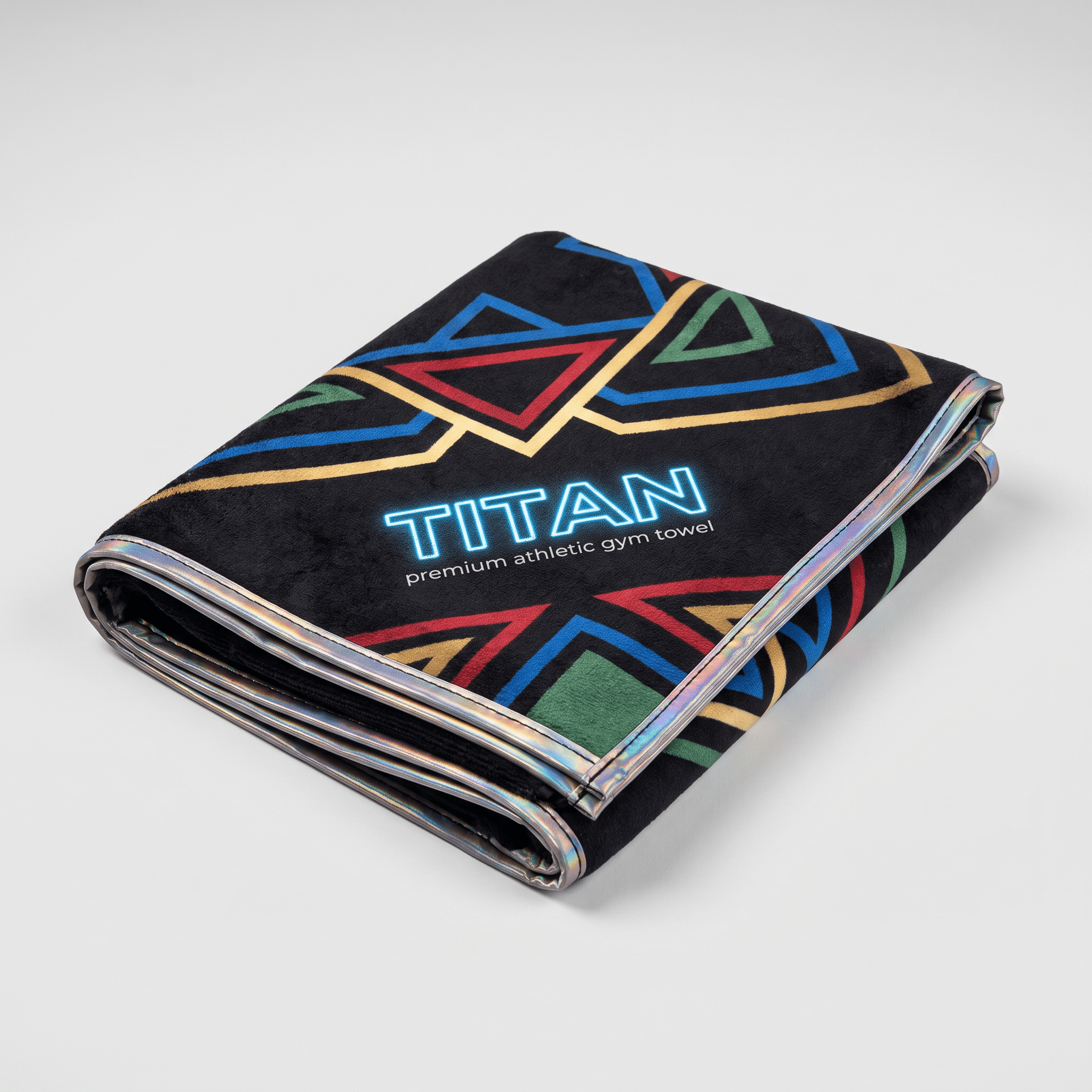 Folded black Titan premium athletic gym towel with colorful geometric shapes and shiny silver trim.
