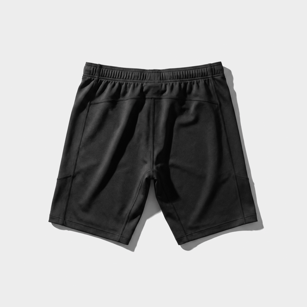 Back view of black athletic shorts with an elastic waistband and paneling.