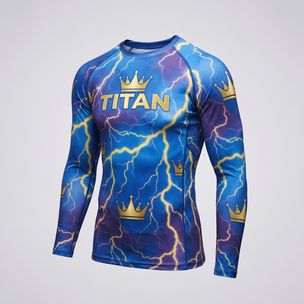 Blue long-sleeve rash guard with yellow lightning and gold crown graphics featuring the word TITAN on the chest.