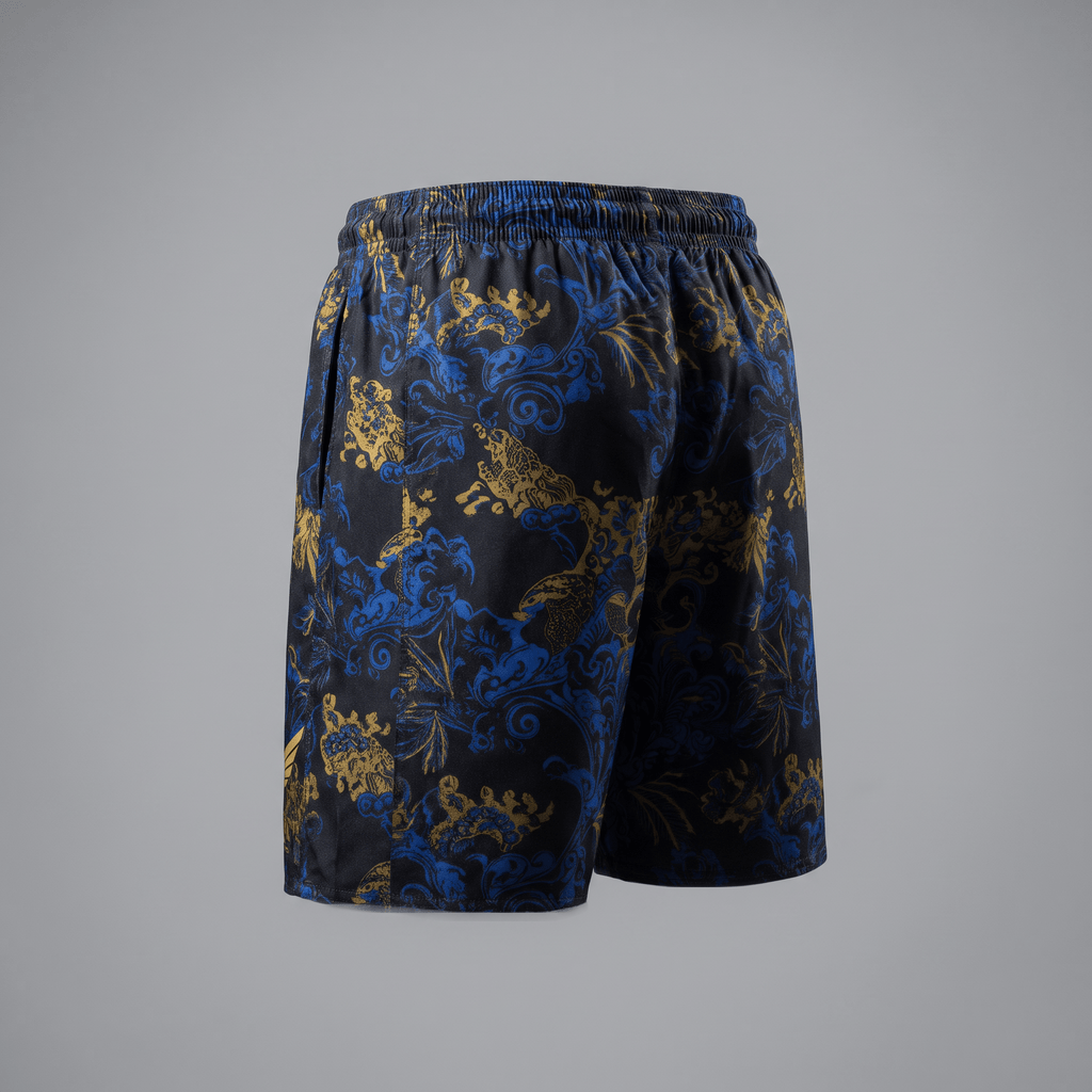Back view of black athletic shorts with blue and gold ornate baroque print and elastic waistband.