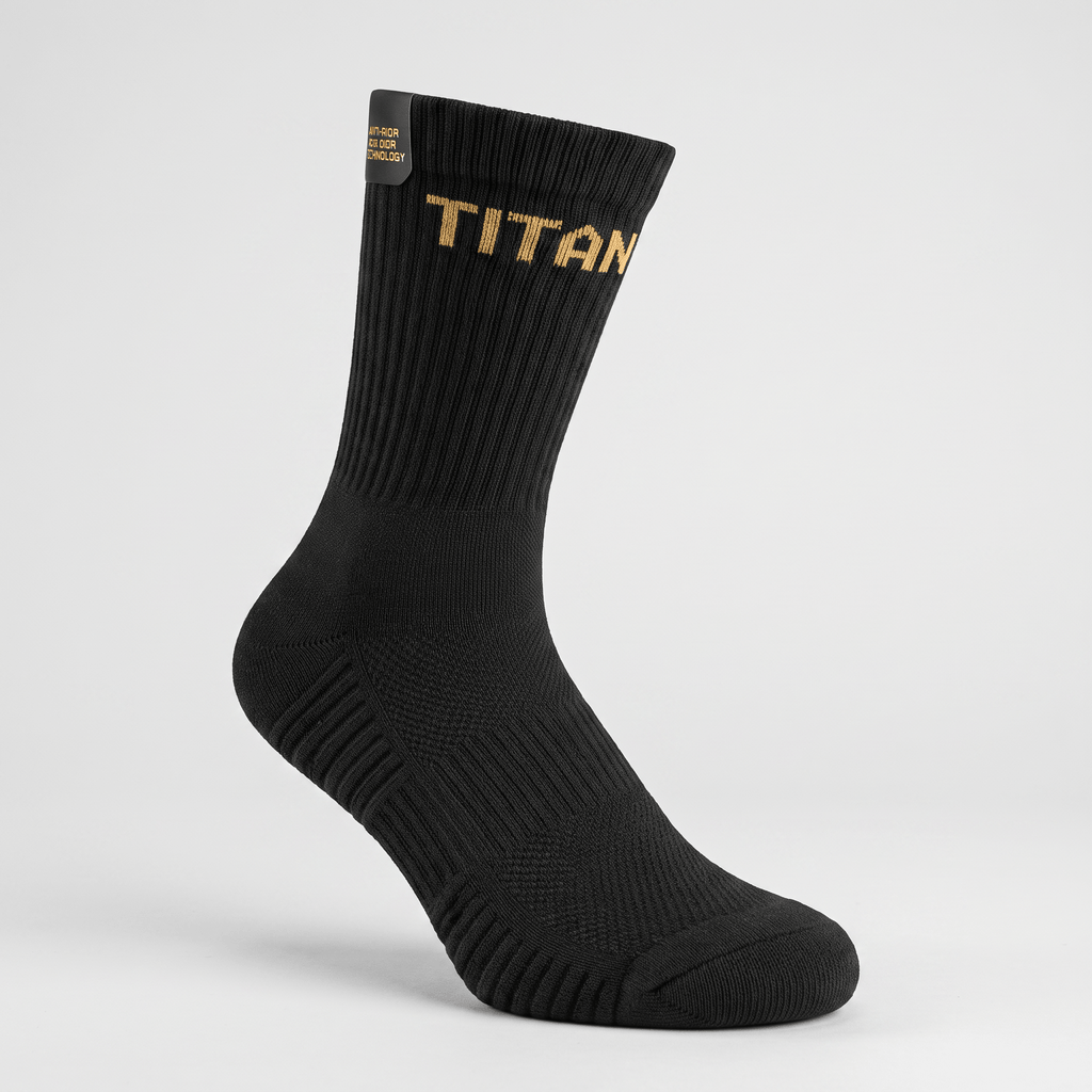 Black crew sock with gold TITAN branding and ribbed athletic support on a light gray background.