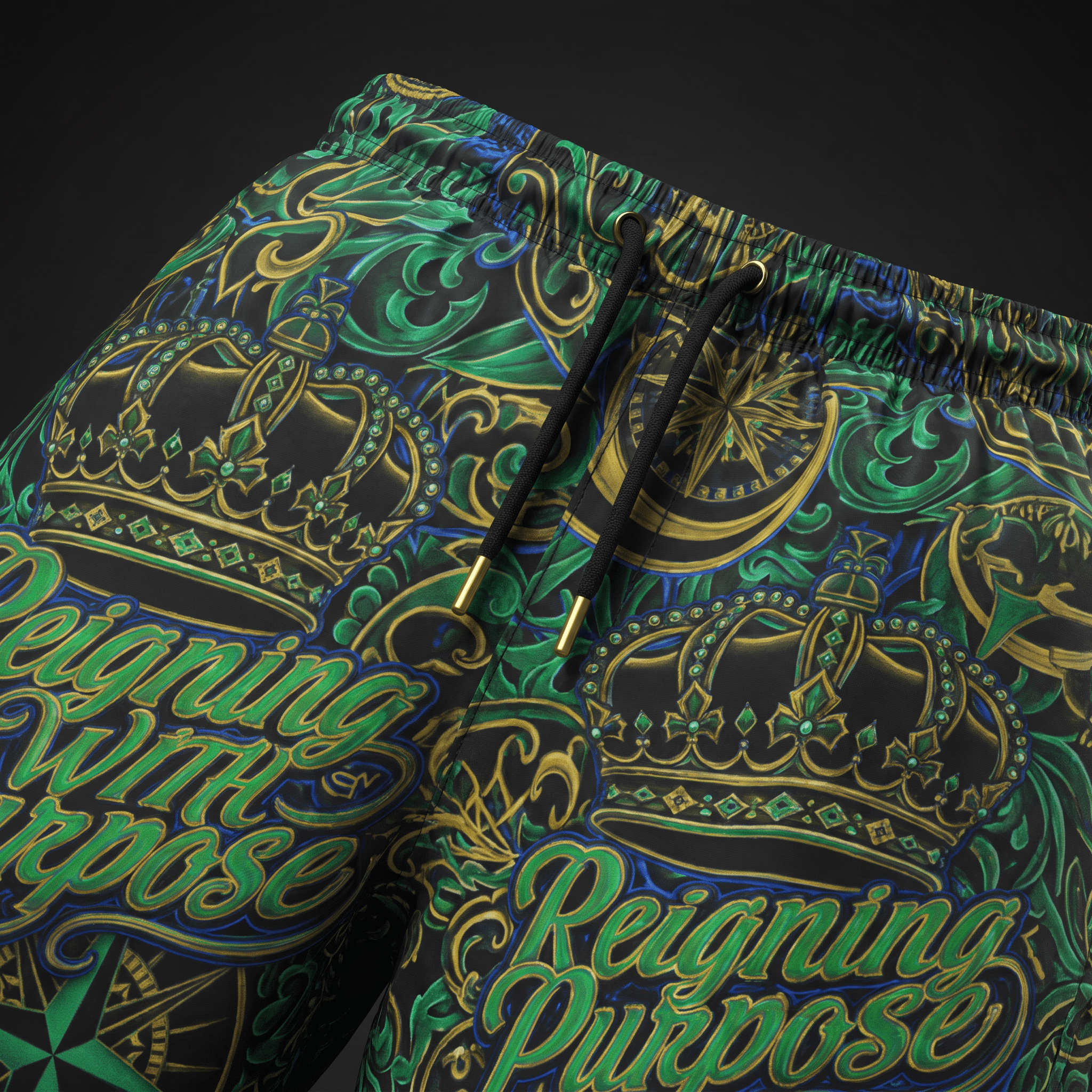 Black athletic shorts featuring a gold and green crown print, black drawstrings, and Reigning With Purpose text.
