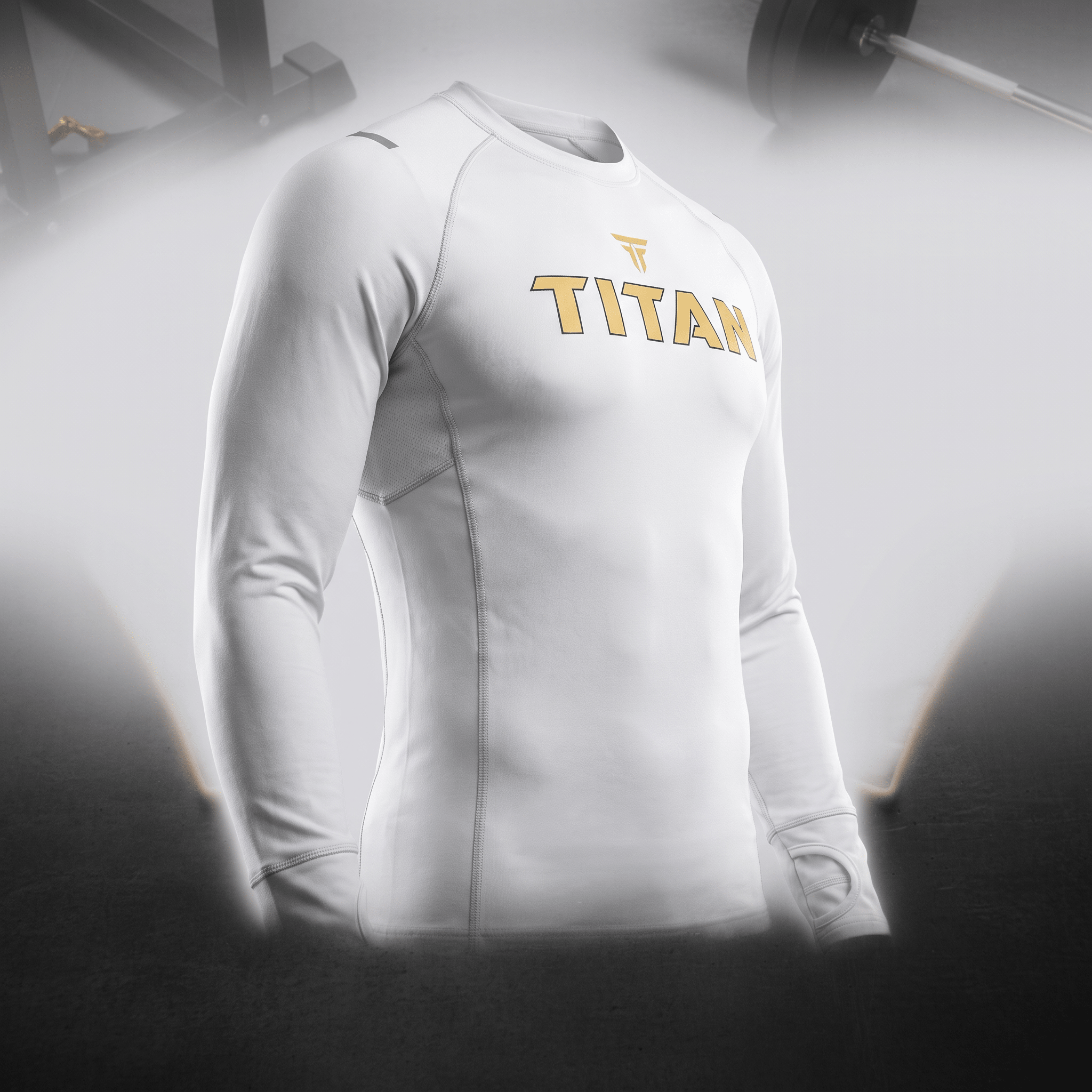 White Titan long-sleeve compression shirt with gold logo for gym training.