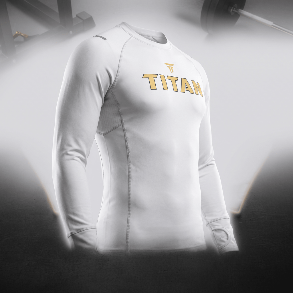 White Titan long-sleeve compression shirt with gold logo for gym training.