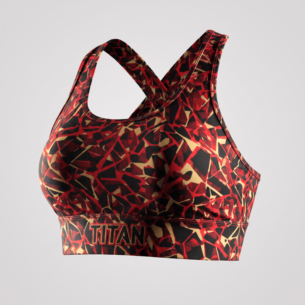 Titan sports bra in red, black, and gold abstract geometric print with crossback straps.