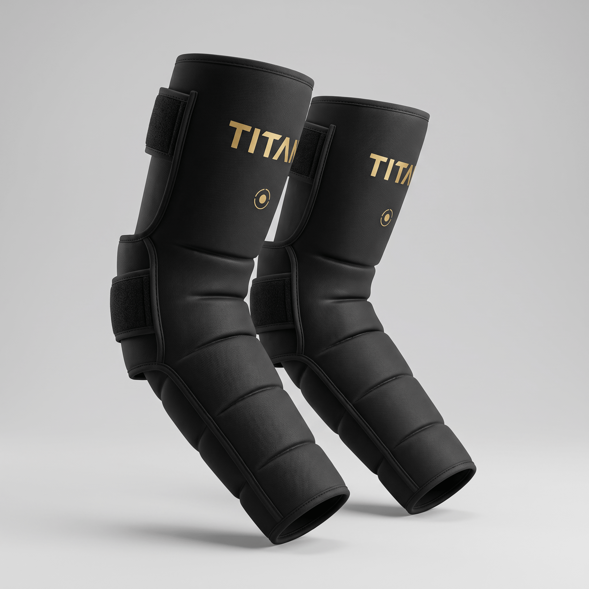 Black Titan elbow sleeves with gold branding, secured with adjustable velcro straps on a light gray background.