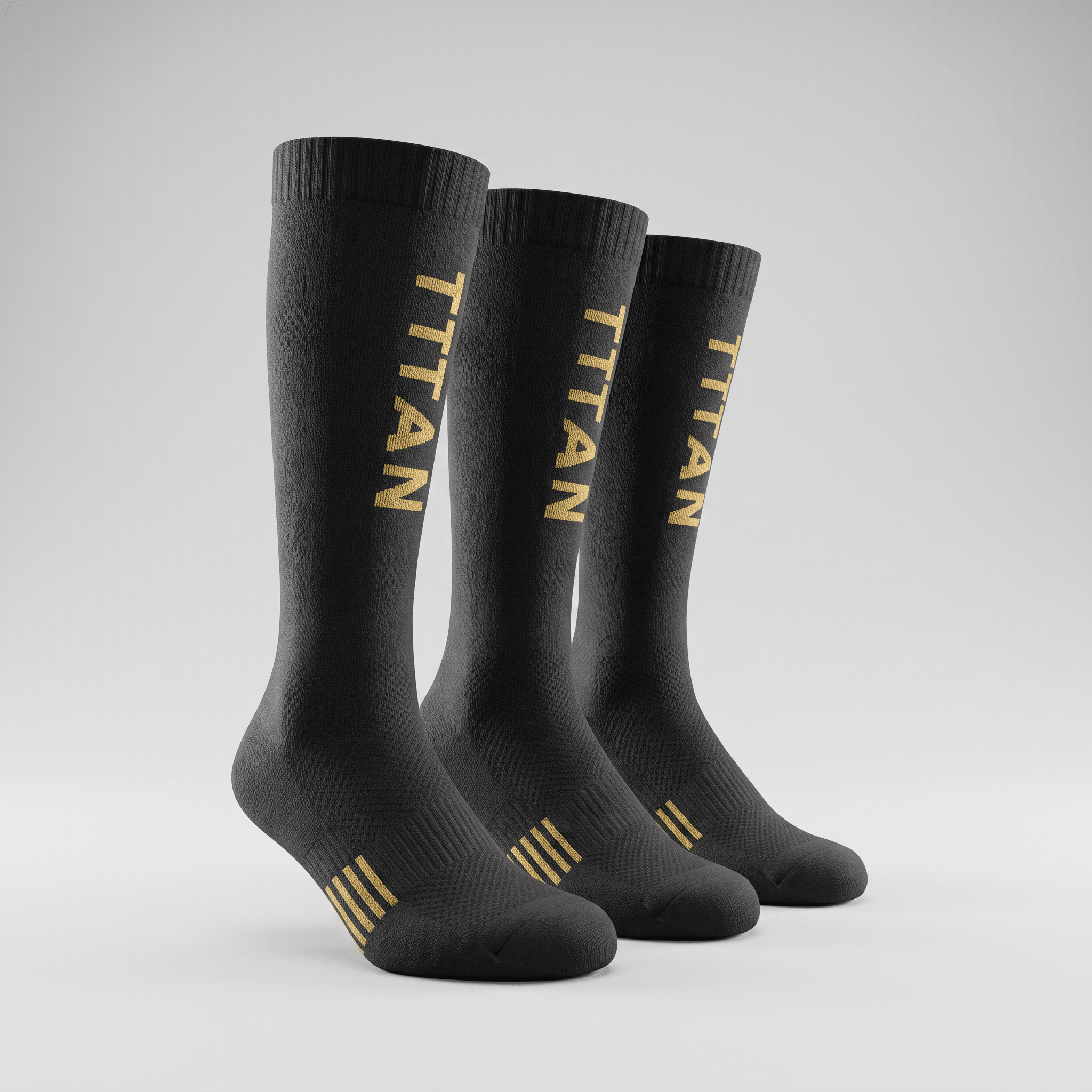 Three black athletic crew socks with gold TITAN branding and stripes on a grey background.