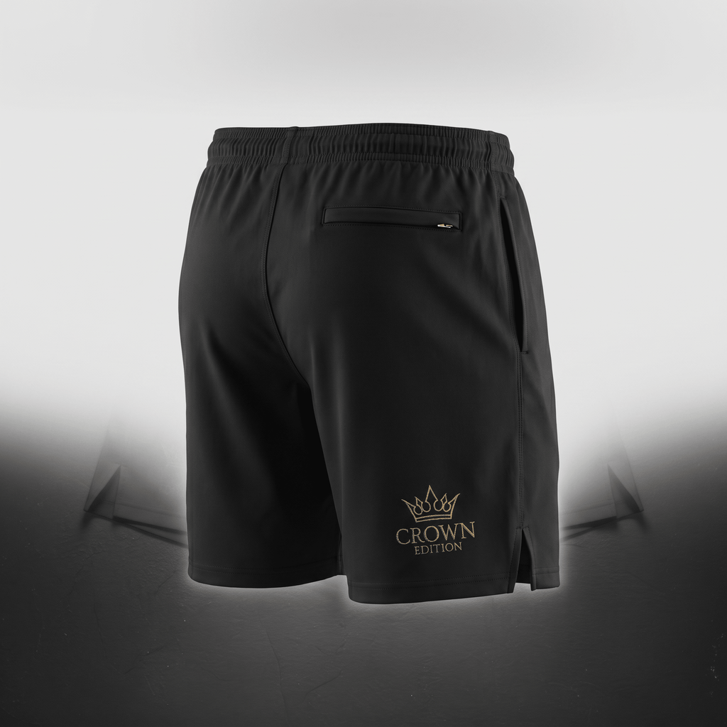 Rear view of black athletic shorts featuring a gold Crown Edition logo, zippered back pocket, and elastic waistband.