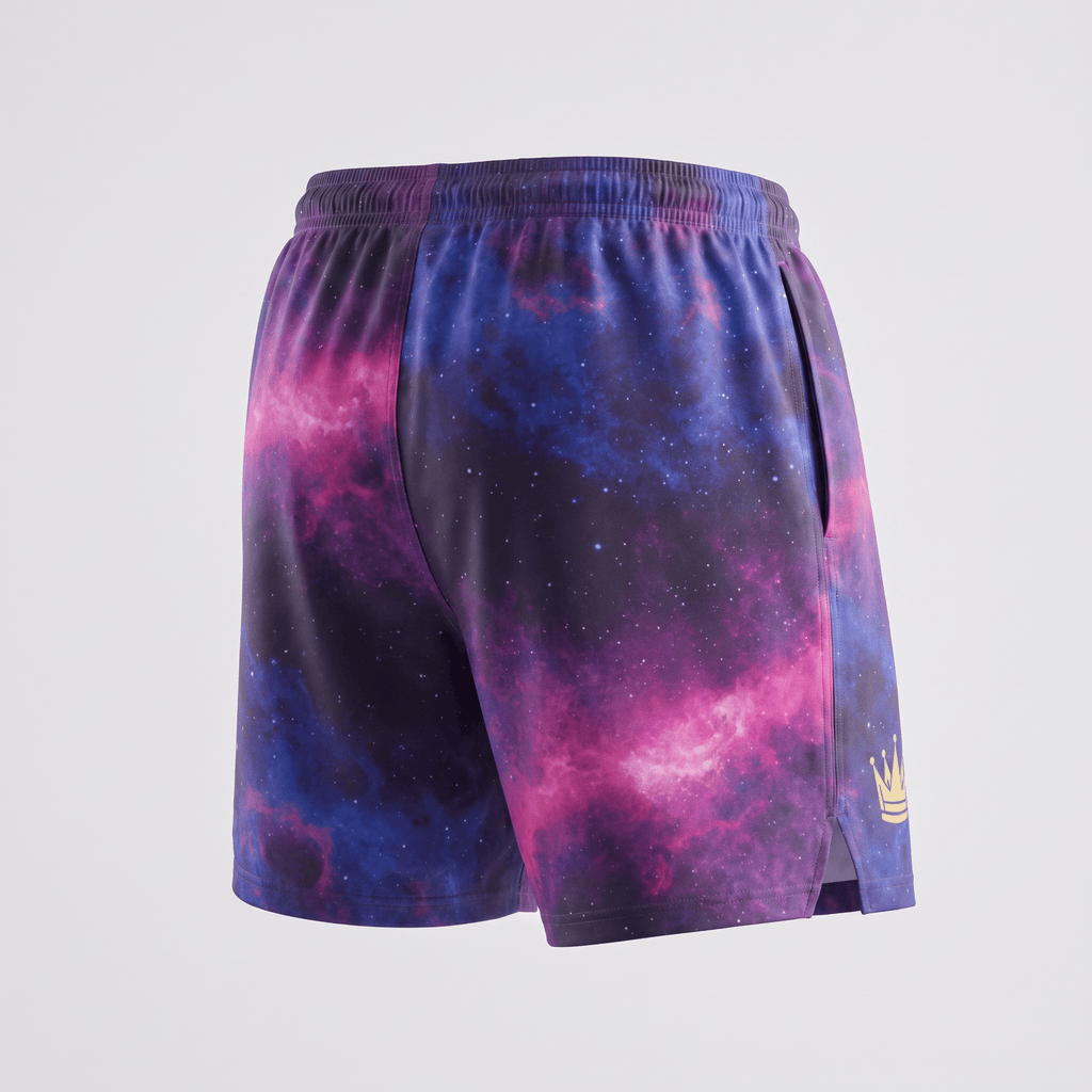 Back view of purple galaxy print athletic shorts with a small gold crown logo on the hem.
