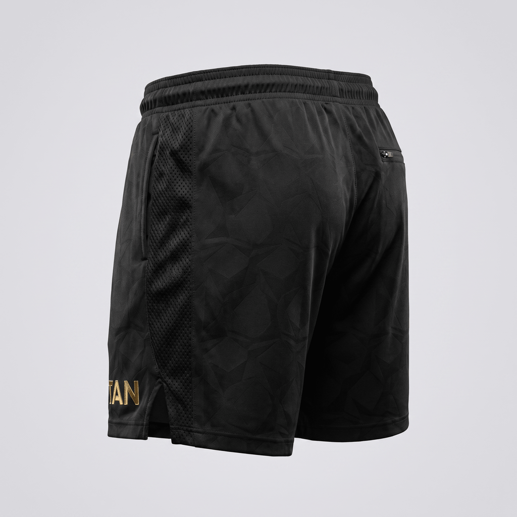 Black athletic shorts with tonal geometric pattern, mesh side panels, and gold logo text.