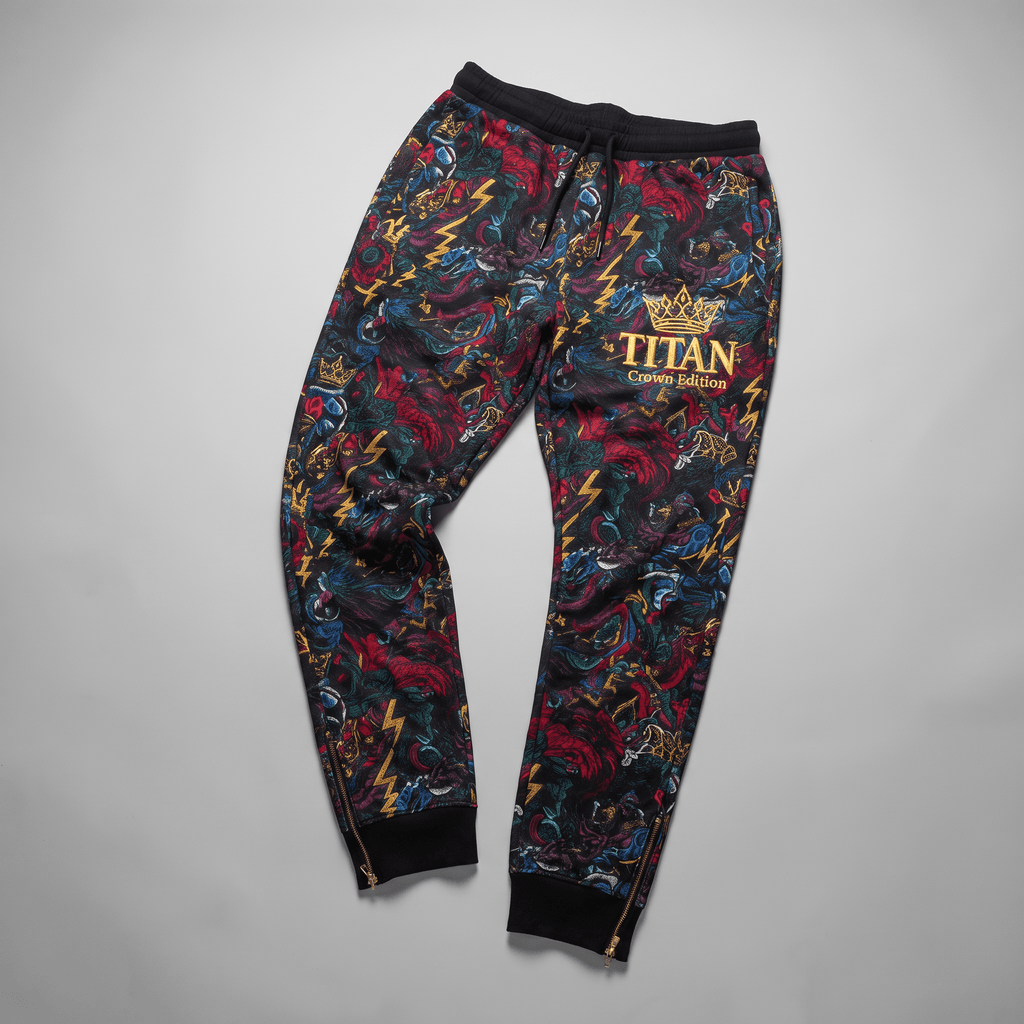 Titan Crown Edition sweatpants with a colorful, busy graphic print, black cuffs, and gold logo detailing.