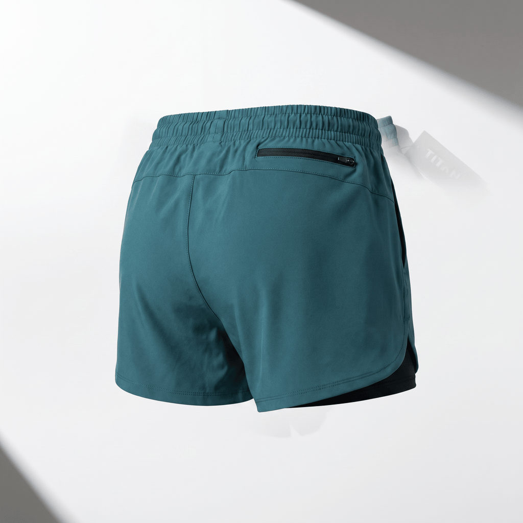 Rear view of teal athletic running shorts with an elastic waistband and a back zipper pocket.