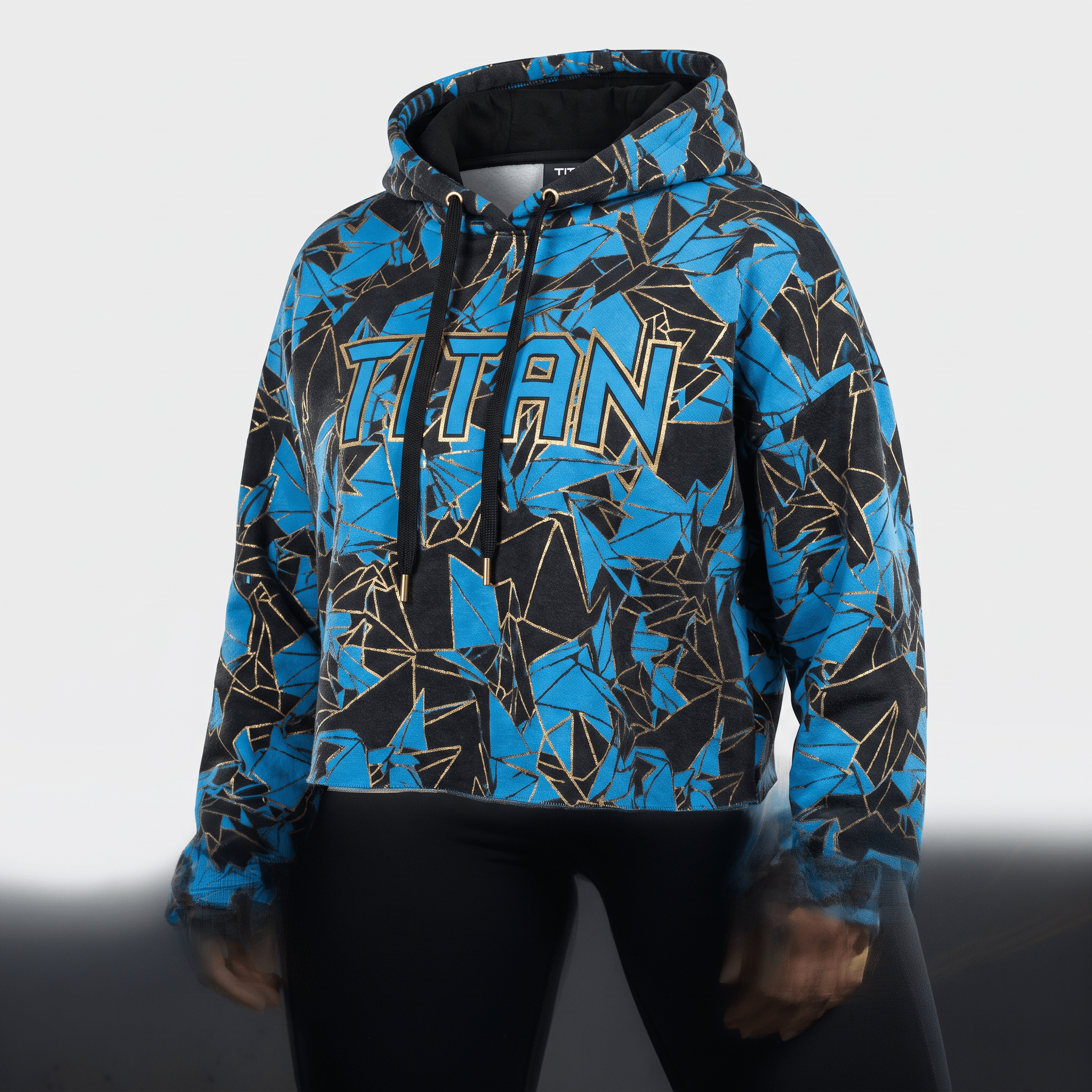 Black, blue, and gold geometric pattern crop hoodie featuring the word Titan across the chest.