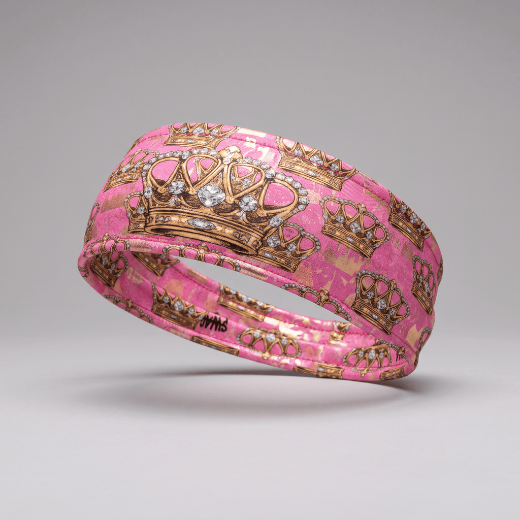 Pink athletic headband featuring a gold crown and diamond print pattern.
