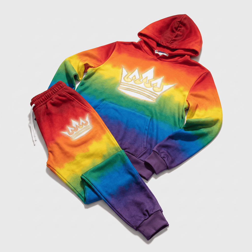 Rainbow tie-dye hoodie and sweatpants set featuring a white embroidered crown logo on the chest and thigh.