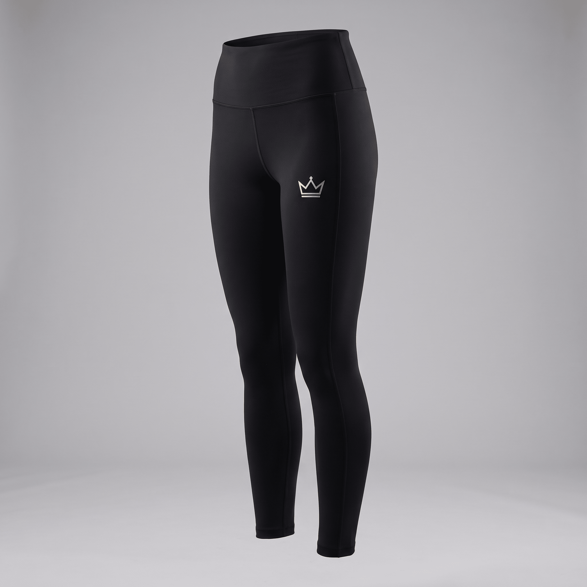 Black high-waisted athletic leggings with a silver crown logo on the left hip shown on a mannequin.