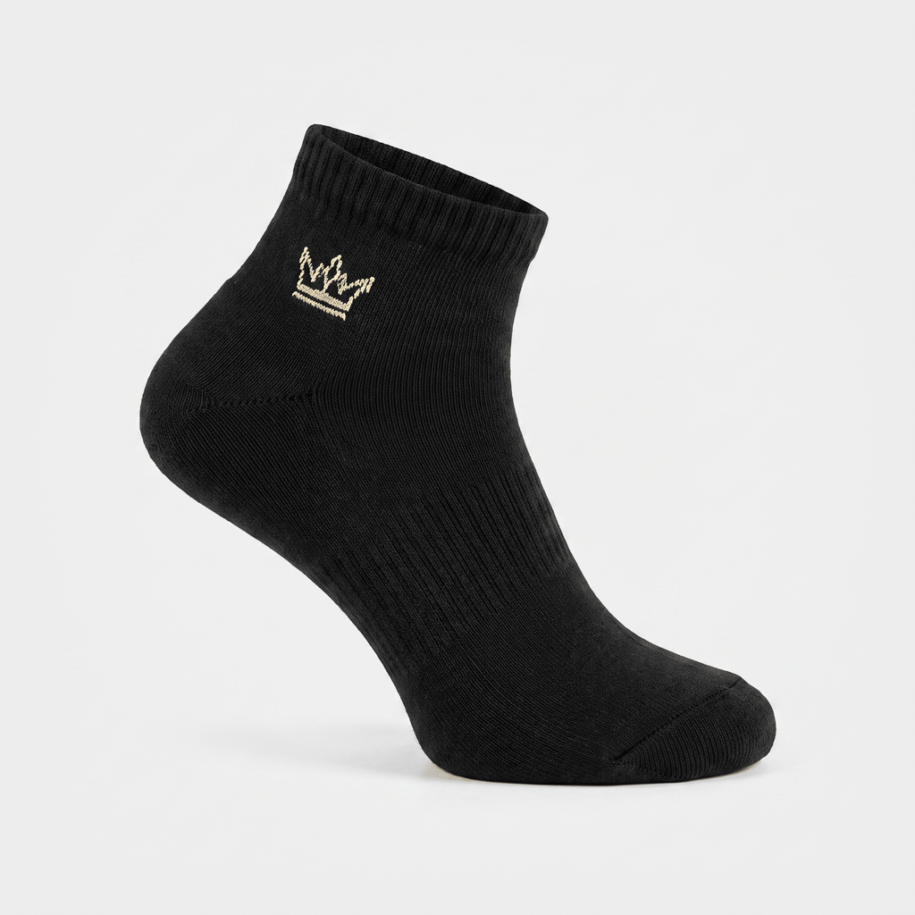 Black ankle sock featuring an embroidered gold crown logo on the ribbed cuff, shown against a plain white background.