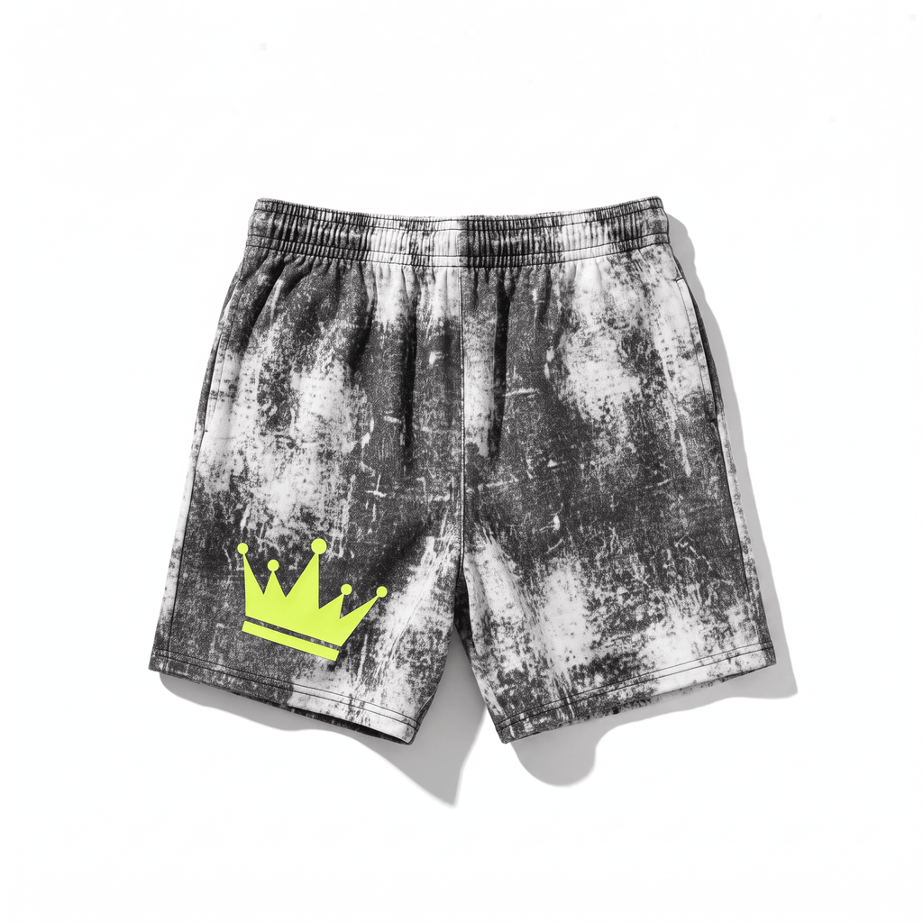 Black and white acid wash fleece shorts with an elastic waistband and a neon yellow crown graphic on the left leg.