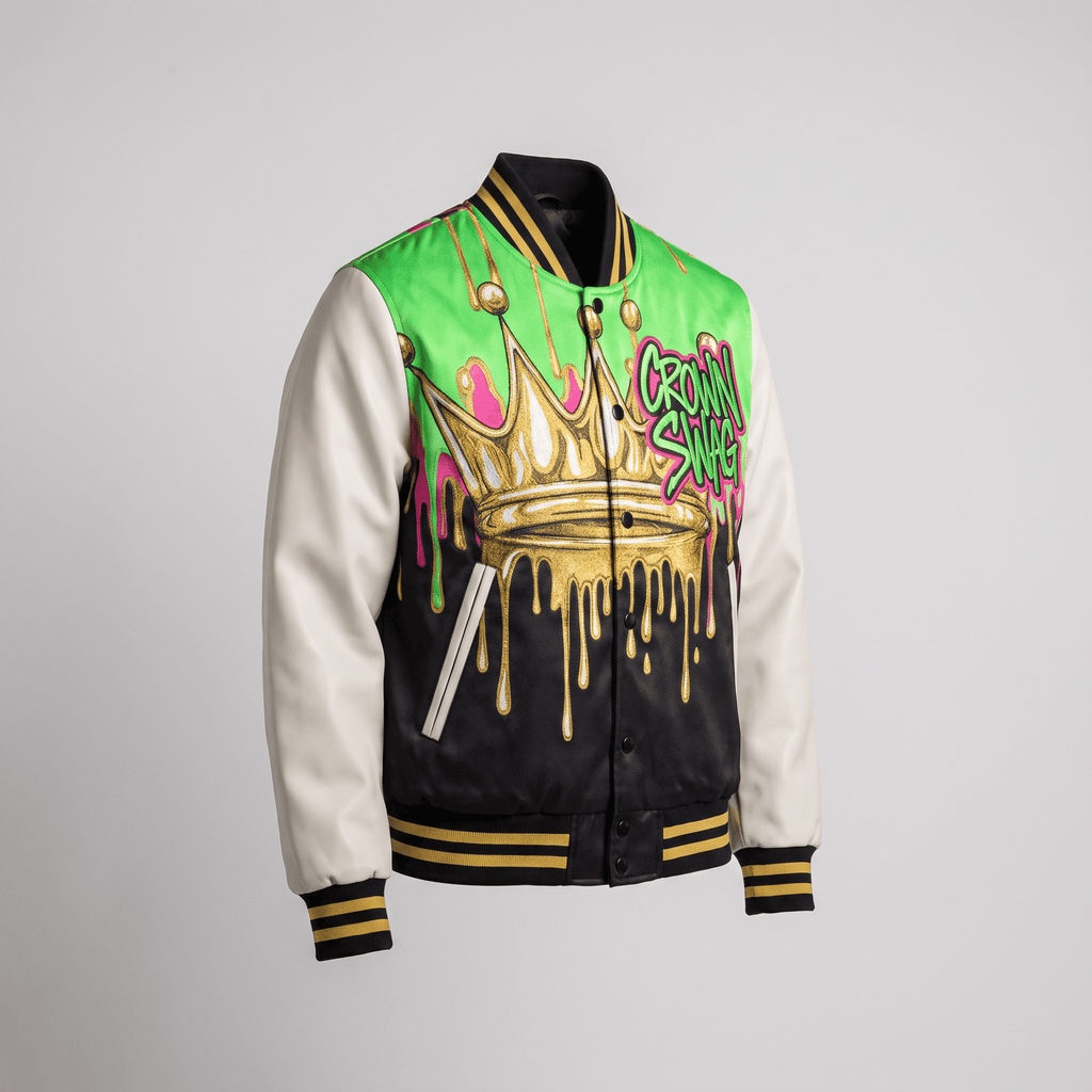 Black, white, and green varsity jacket with gold crown graphic and striped ribbed trim.