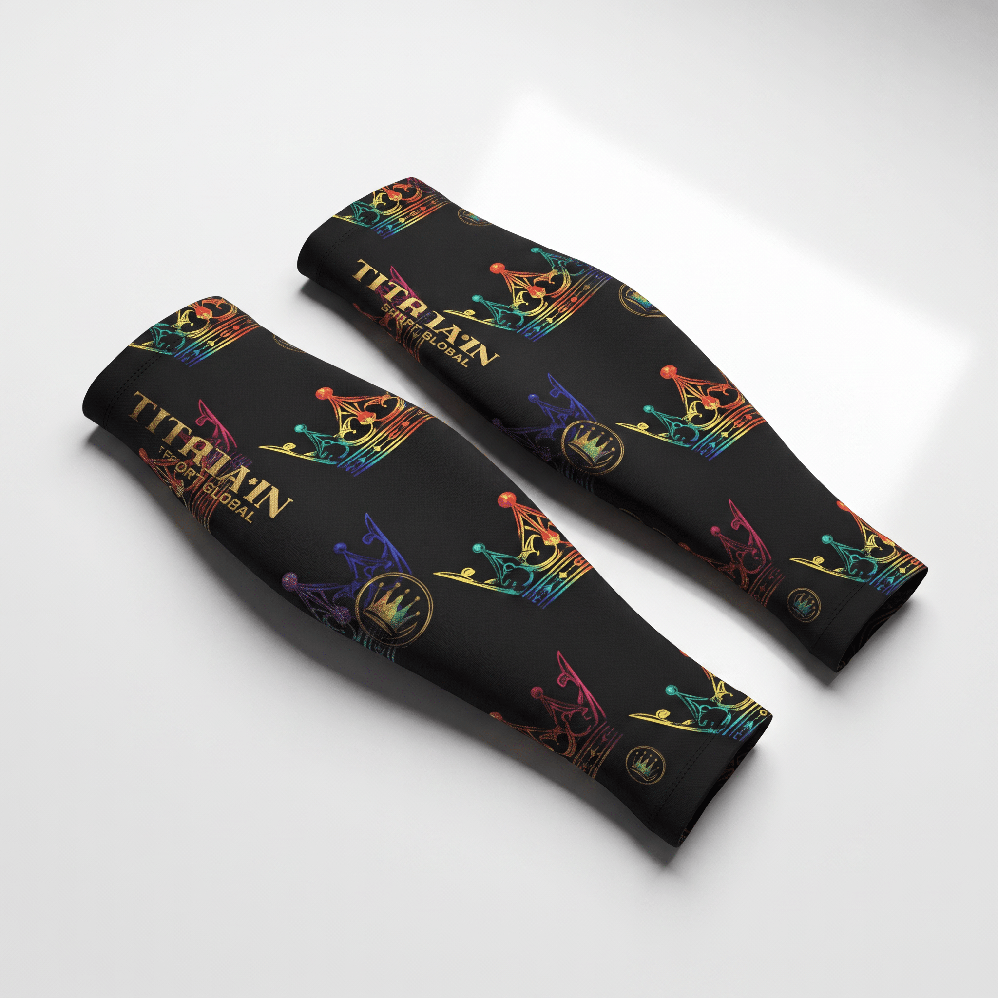 Pair of black compression arm sleeves featuring a colorful crown pattern and gold brand logo.