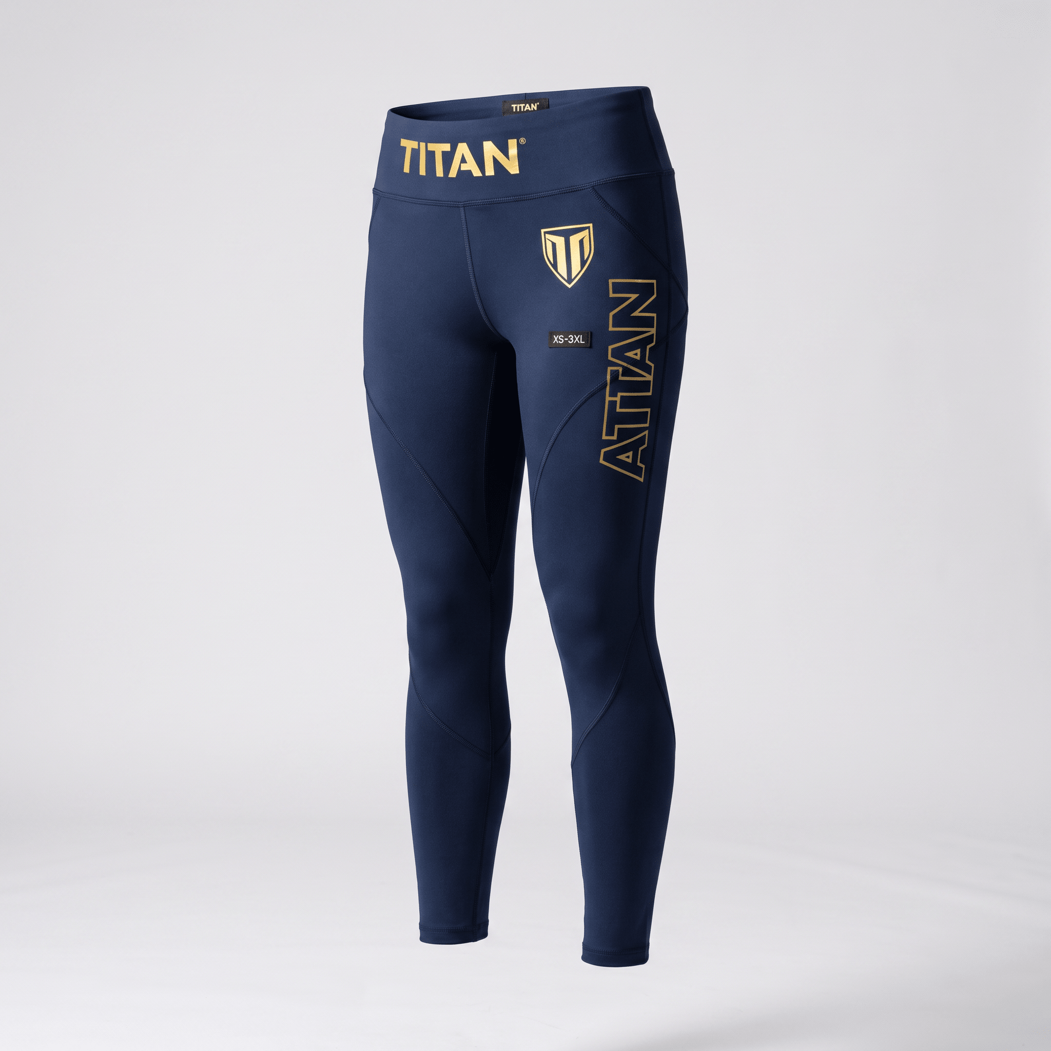 Navy blue Titan athletic leggings with gold branding and logo on a light gray background.