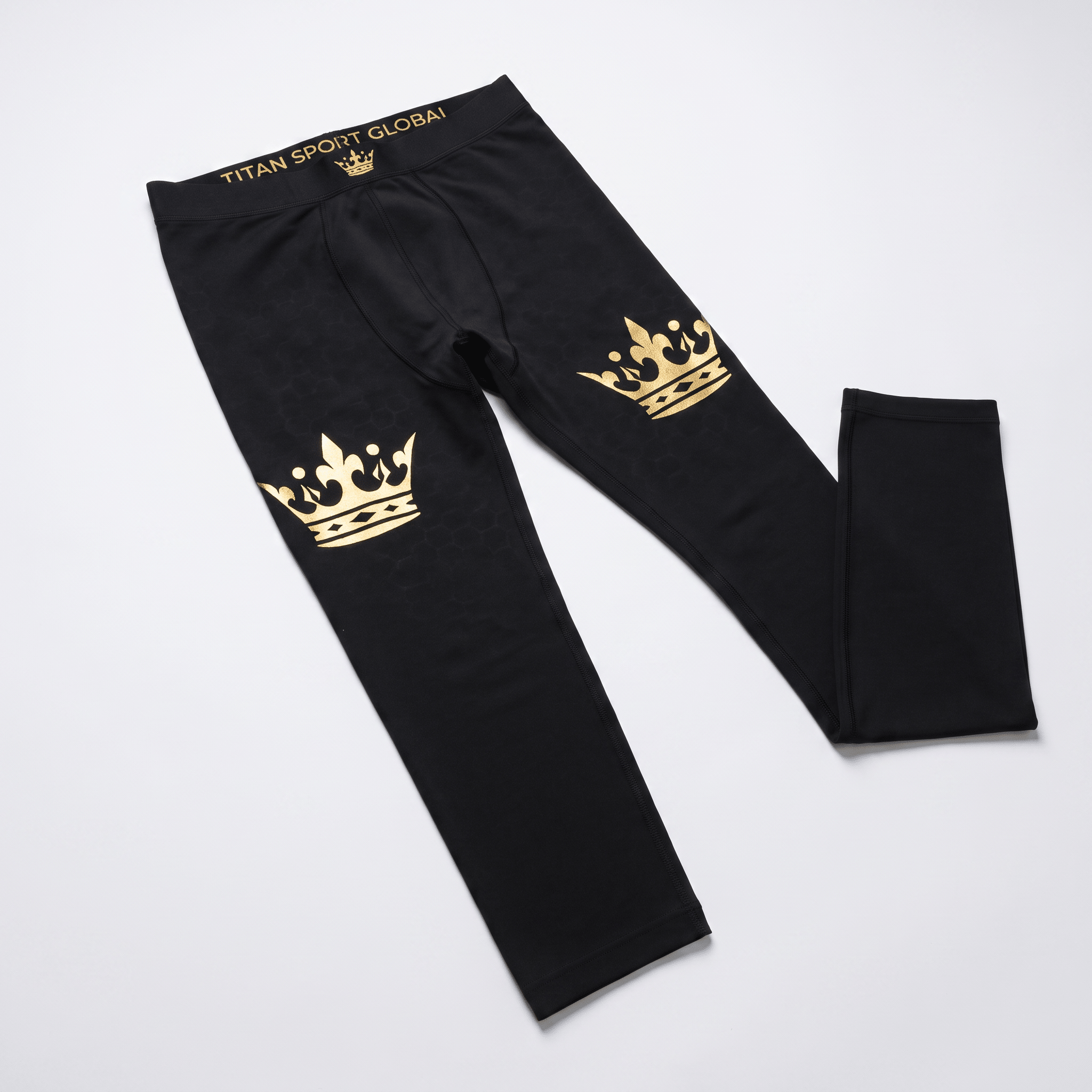 Black athletic leggings with gold crown graphics on the thighs and Titan Sport Global waistband.