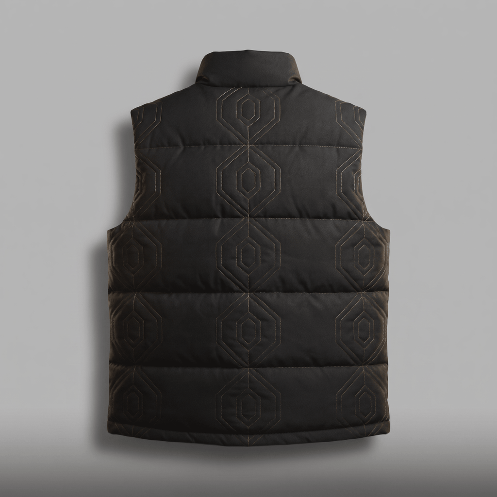 Back view of a black puffer vest with geometric hexagonal stitching on a grey background.