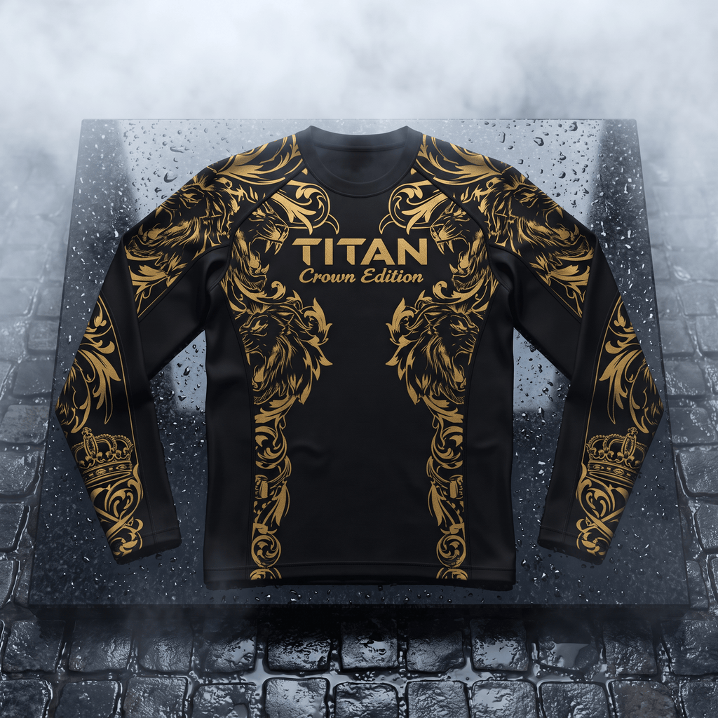 Black long-sleeve athletic rash guard with gold ornate lion and crown patterns and "TITAN Crown Edition" text.