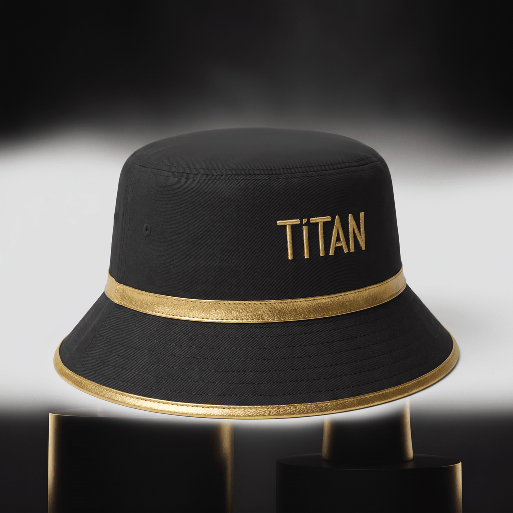 Black bucket hat with gold trim and embroidered Titan logo on a dark background.