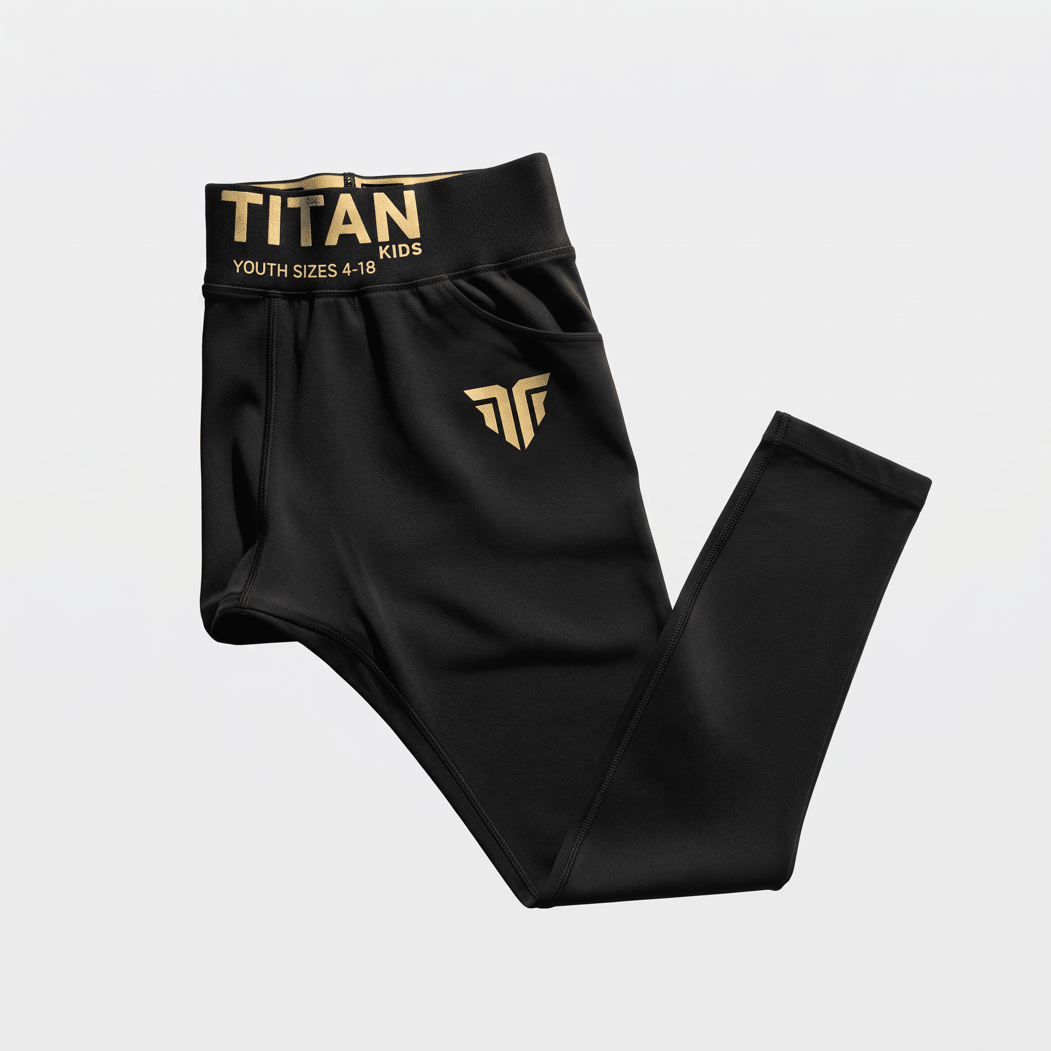 Black Titan Kids athletic leggings with gold waistband text and logo on white.