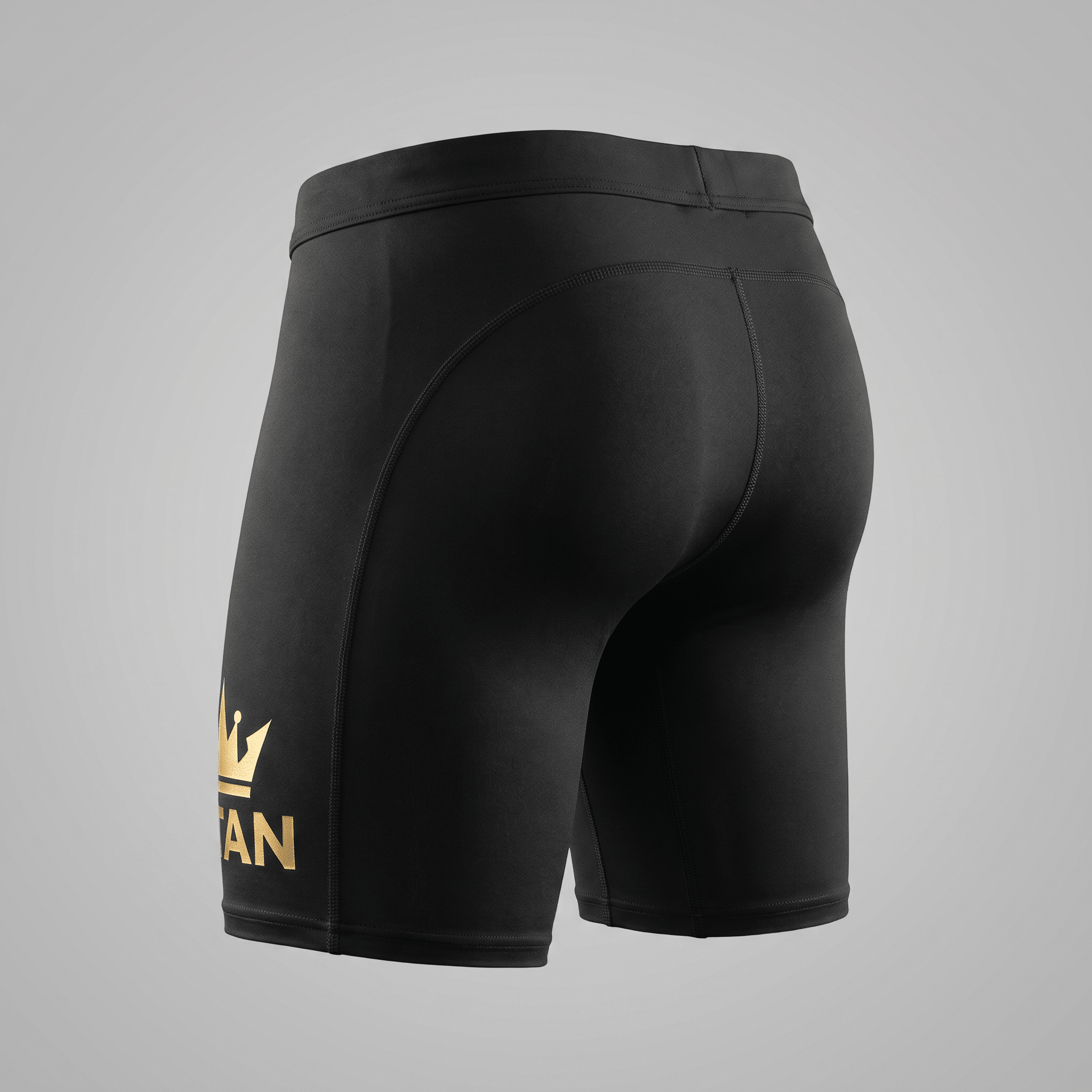 Rear view of black athletic compression shorts with a gold crown logo on the leg.