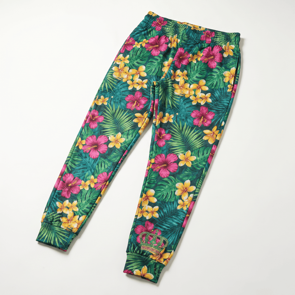 Green tropical floral print jogger sweatpants with pink and yellow flowers and an embroidered crown on the ankle.