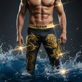 Black TITAN swim trunks with gold dragon and lion graphic, featuring a gold branded waistband, worn in splashing water.