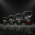 TITAN Kettlebell Set — Five matte black cast iron kettlebells with gold crown logo and color-coded weight rings