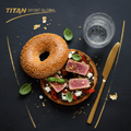TITAN Mediterranean Tuna Olive Bagel Breakfast flat lay dark luxury
