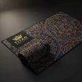 TITAN Sport Global microfiber gym towel with blue, red, and gold mandala patterns and a gold crown logo on black.