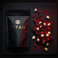 TITAN Keto Chocolate Bark Macadamia & Raspberry — elegant close-up overhead with freeze-dried raspberries and macadamia nuts on dark chocolate bark