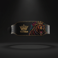 Black leather powerlifting belt with gold stitching, "TITAN" logo, and a roaring bear wearing a crown graphic.