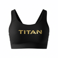 Black TITAN sports bra with a wide ribbed hem, scoop neckline, and metallic gold logo centered on the chest.