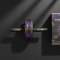 TITAN Ab Roller V2 with black handles, purple and gold geometric wheel tread, and matching product box on dark surface.